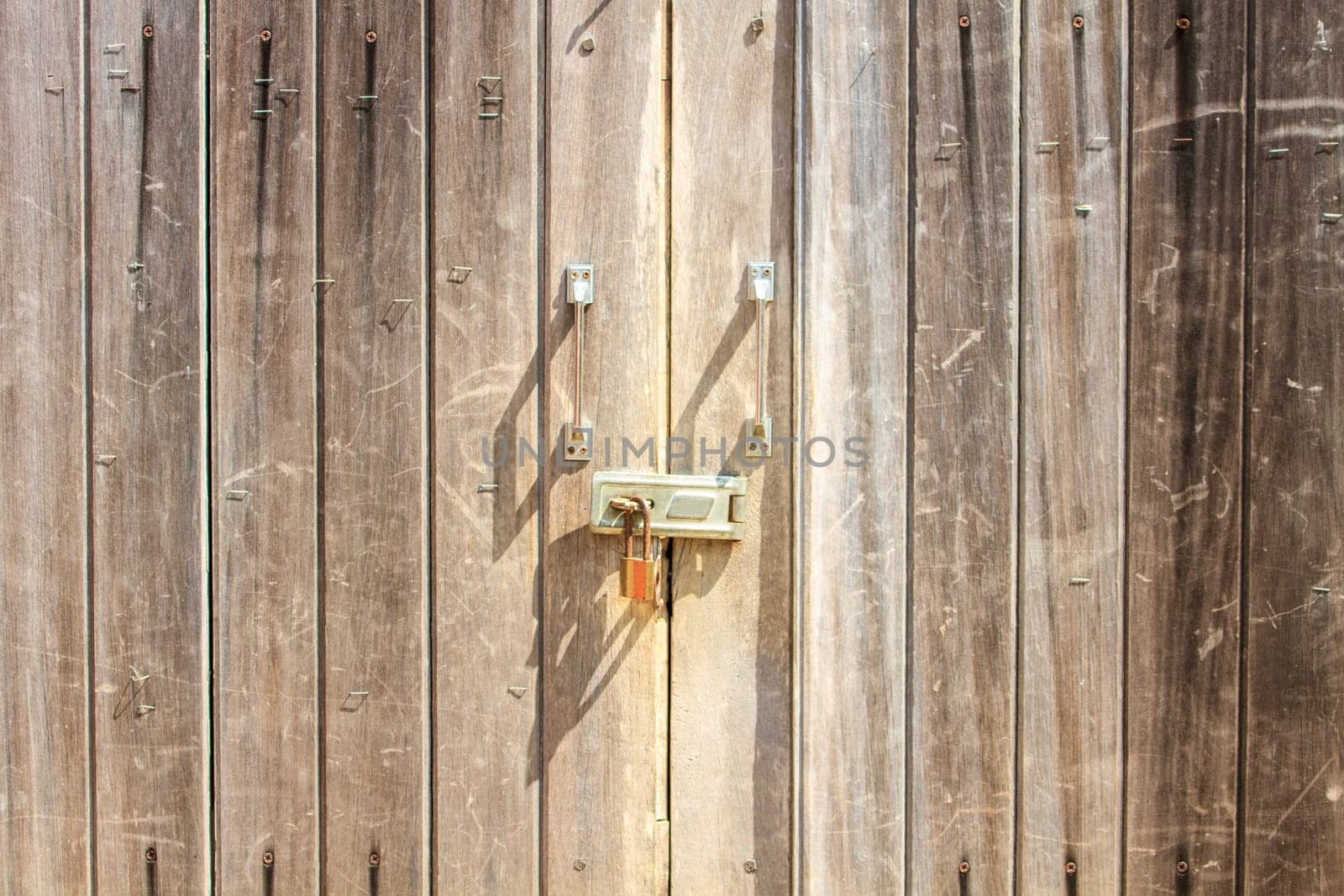 Padlock on wooden background, pad lock secures an old door