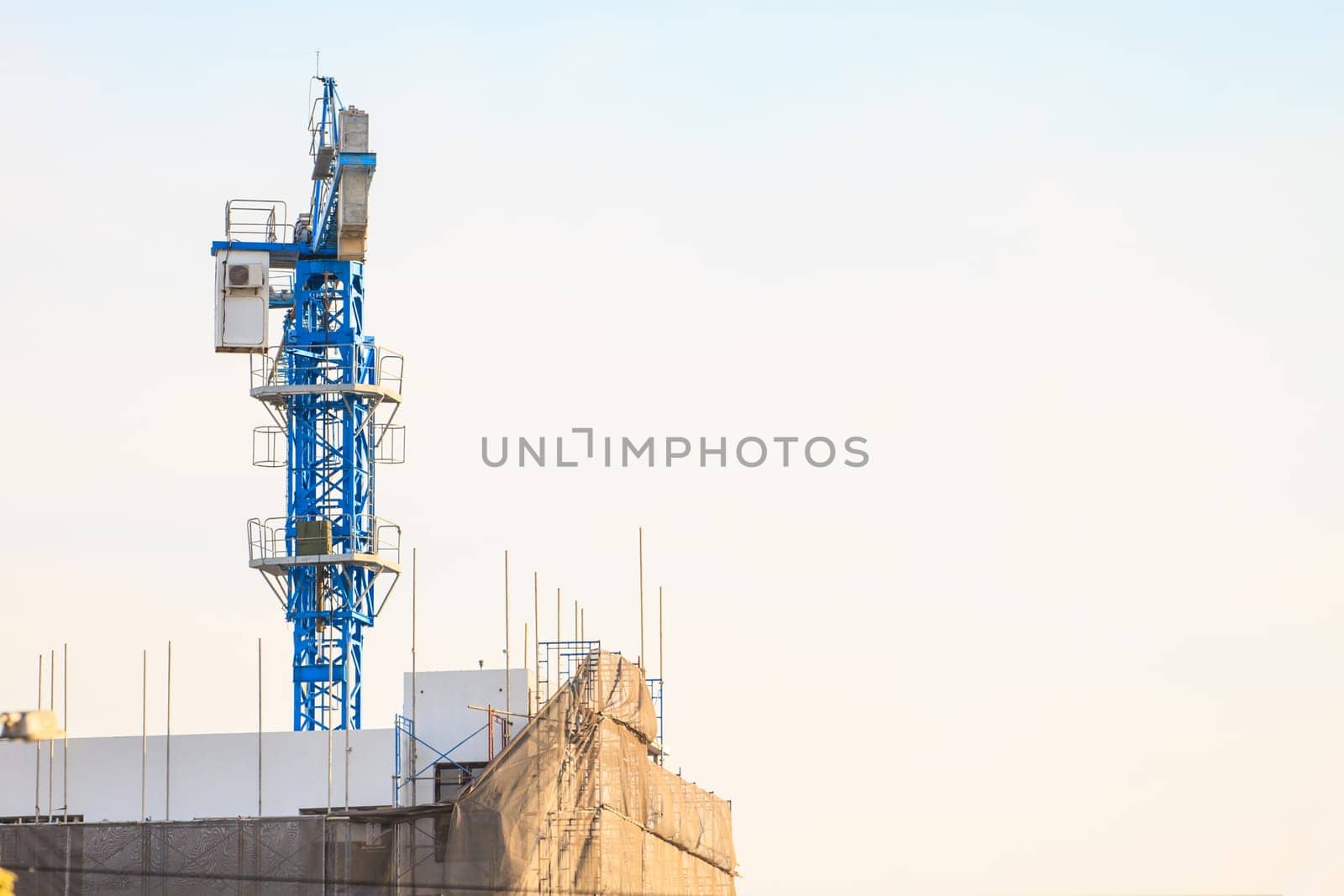 Construction site with cranes on sky background