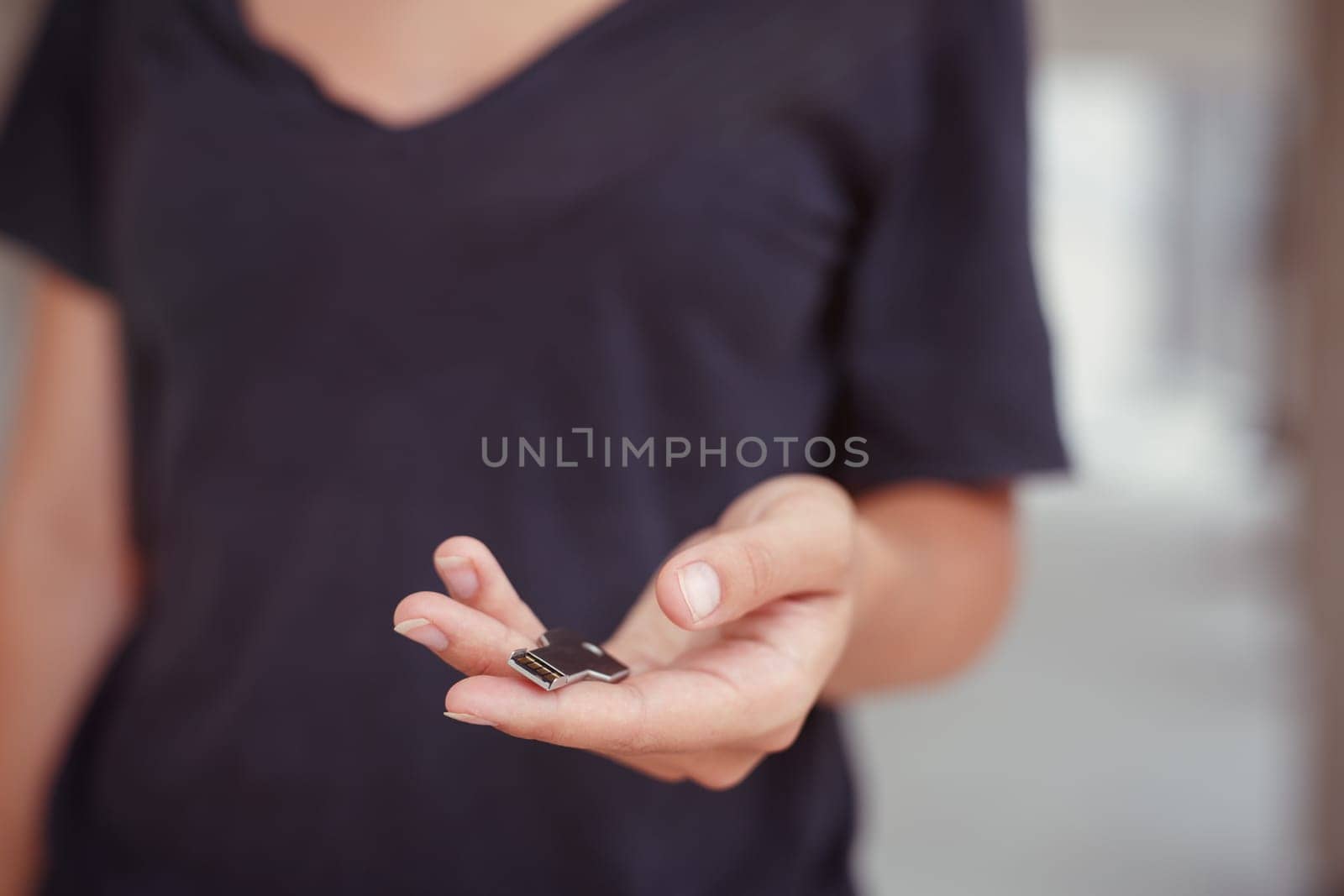 USB stick in the form of a key in a woman's hand.