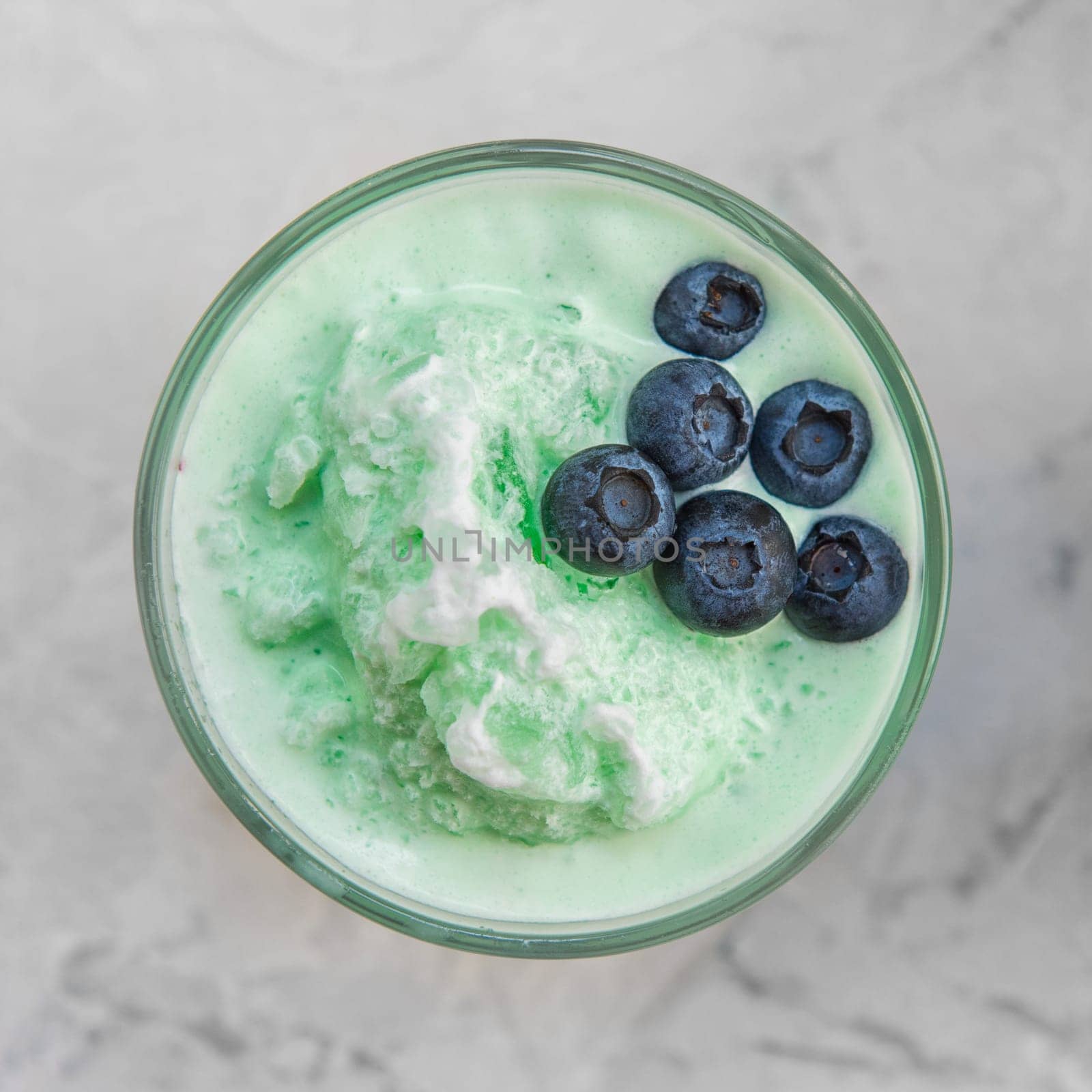 Blueberry smoothie on a white concrete background. Square cropping