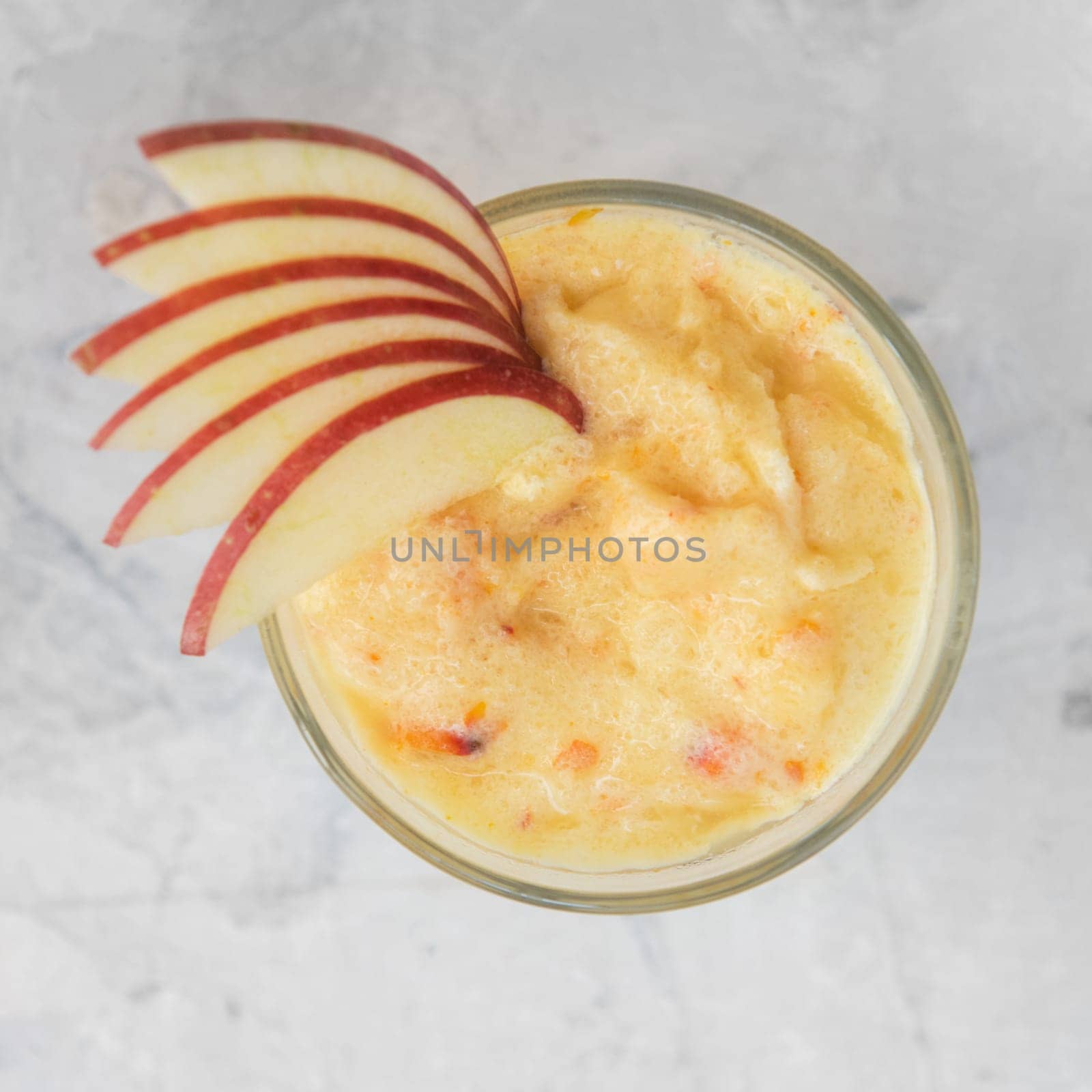 Apple smoothie on a white concrete background. Square cropping