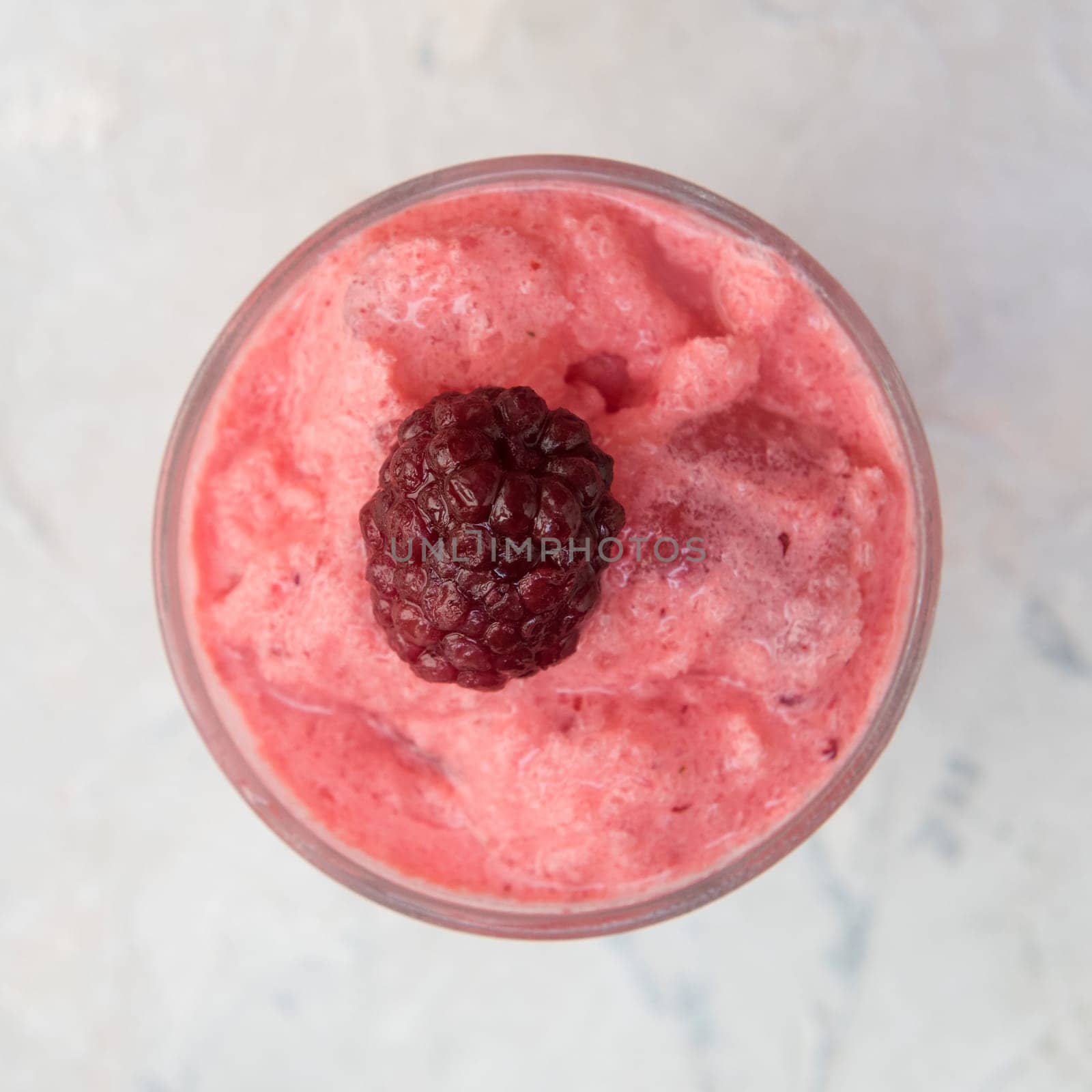Blackberry smoothie on a white concrete background. Square cropping