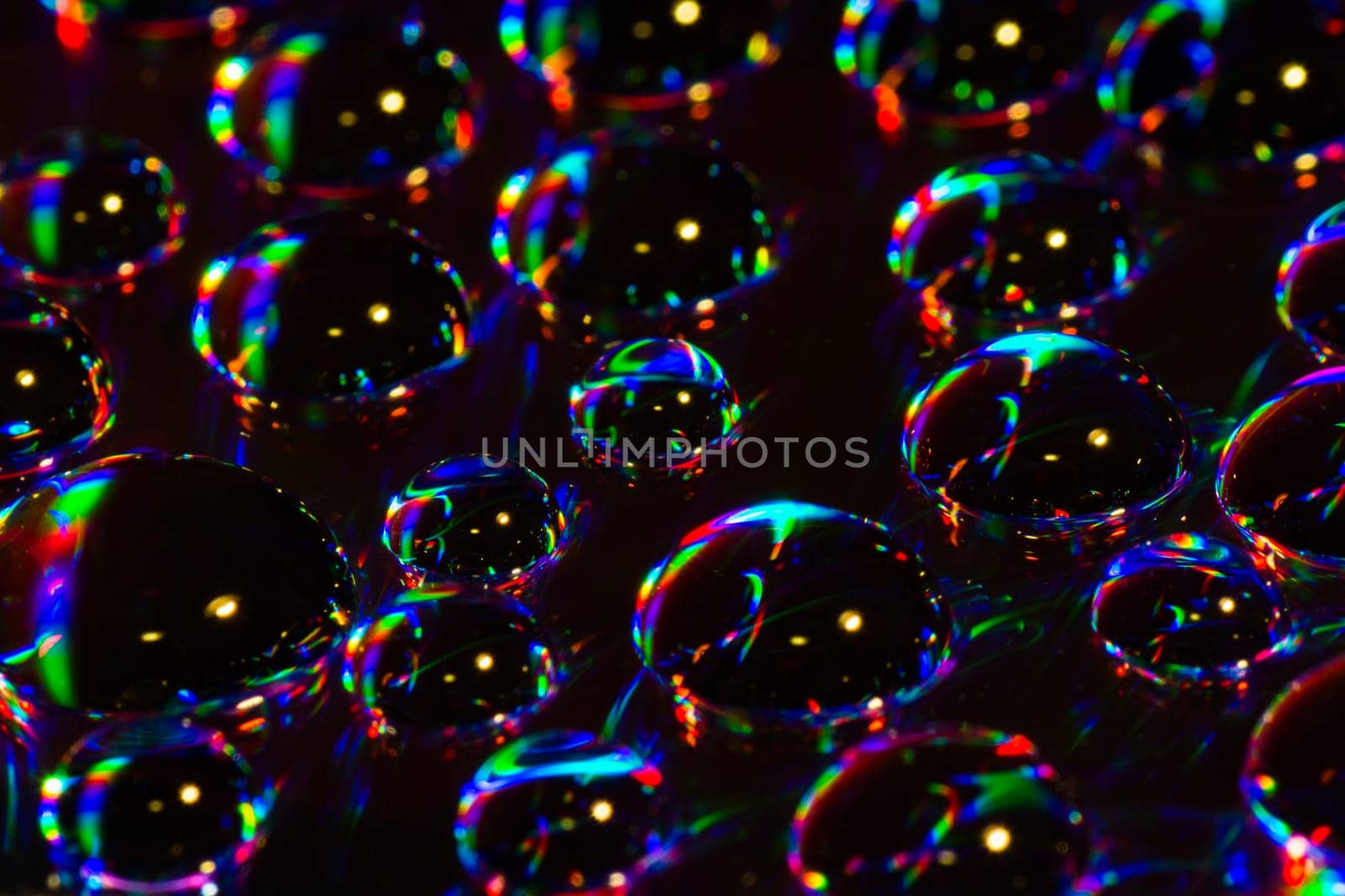 Colorful water drops are on black background.