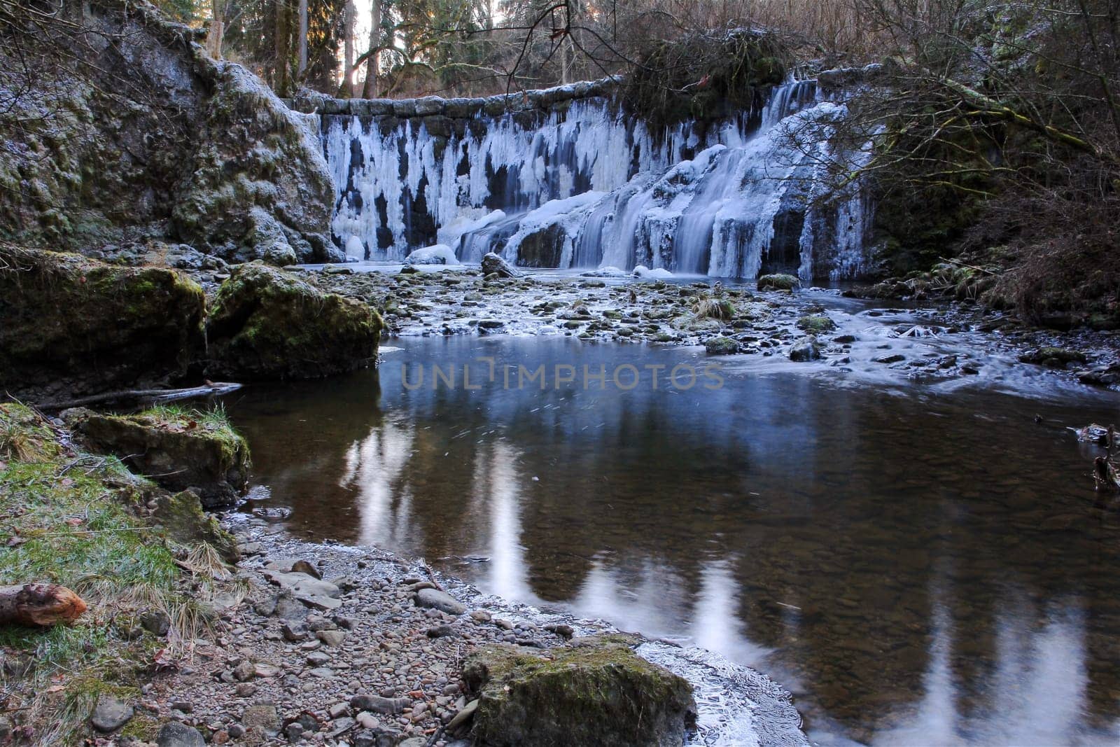 A frozen waterfall in winter. Frozen waterfall with icicles
