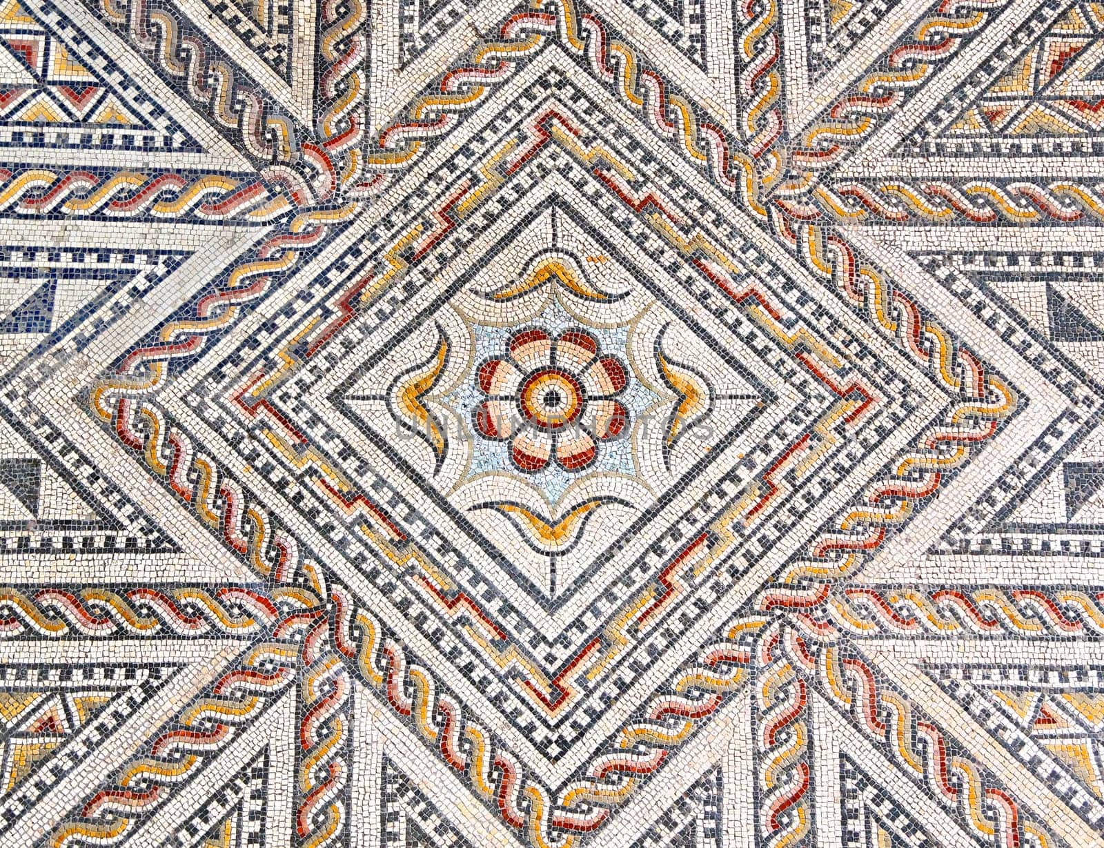 Ancient roman stone mosaic floor with geometric design
