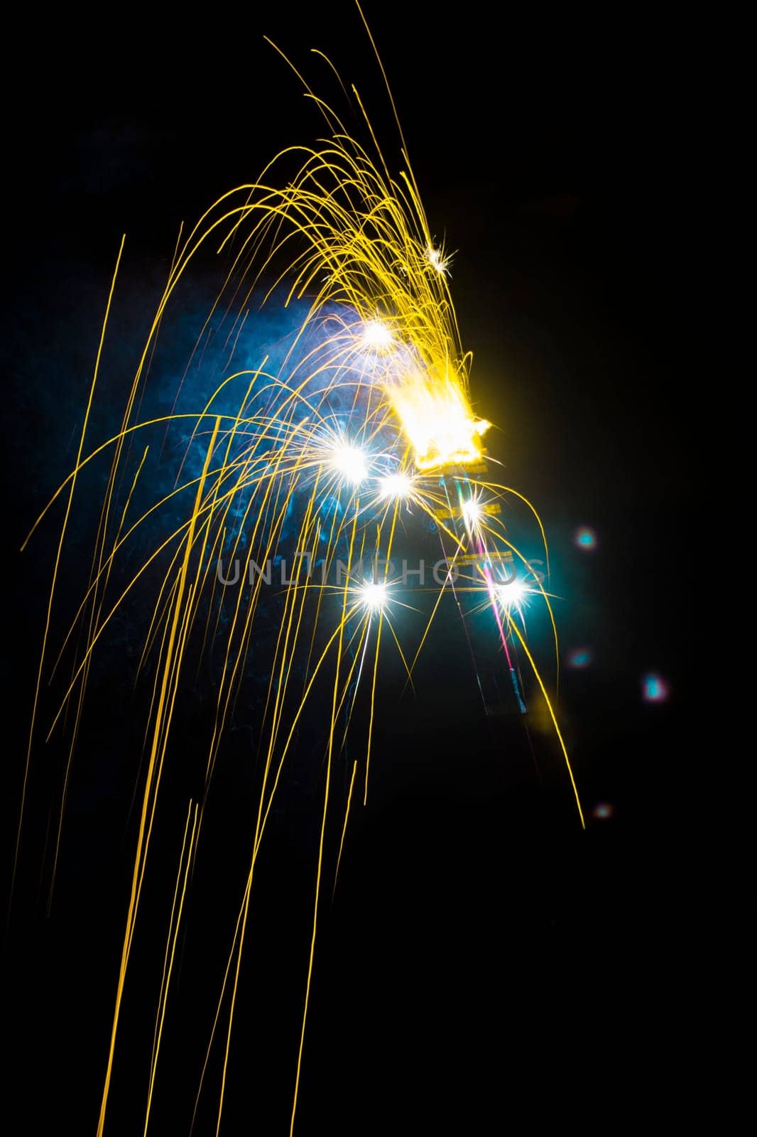 The yellow sparkler is on black background.
