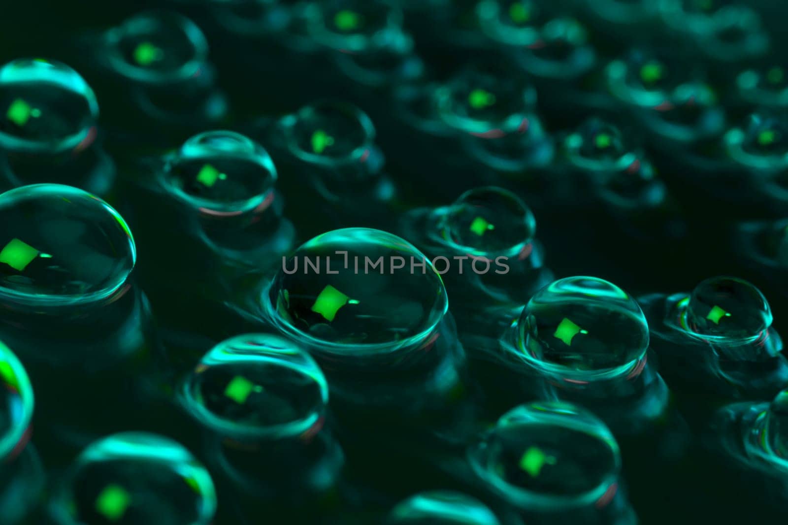 Abstract water drops are on green background.