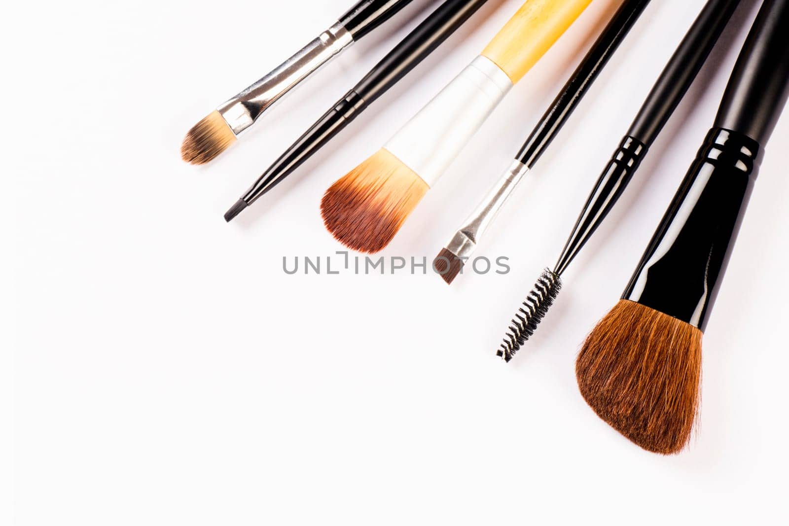 Different brushes for make-up are on white background.