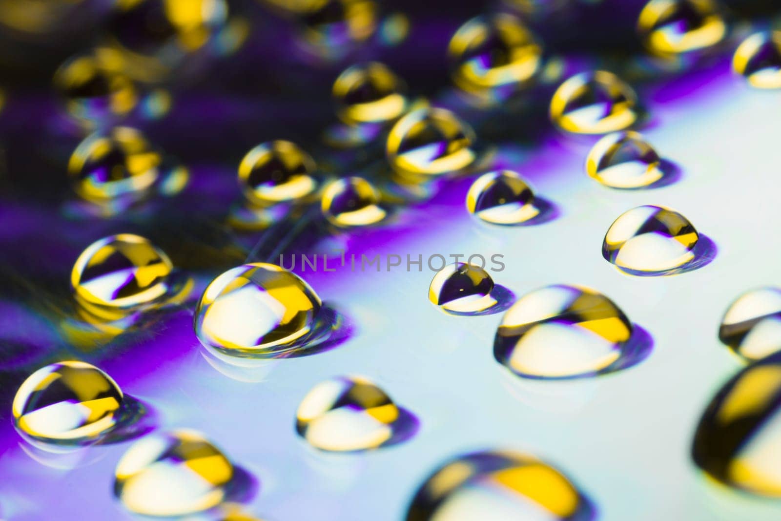Yellow water drops are on purple background.