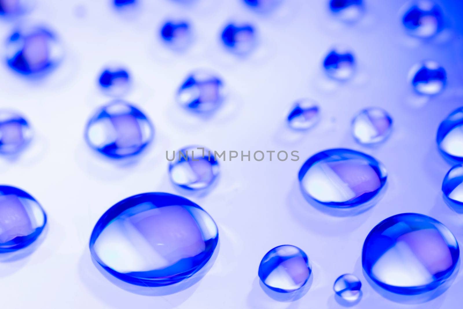 Abstract background is from blue water drops on white background.
