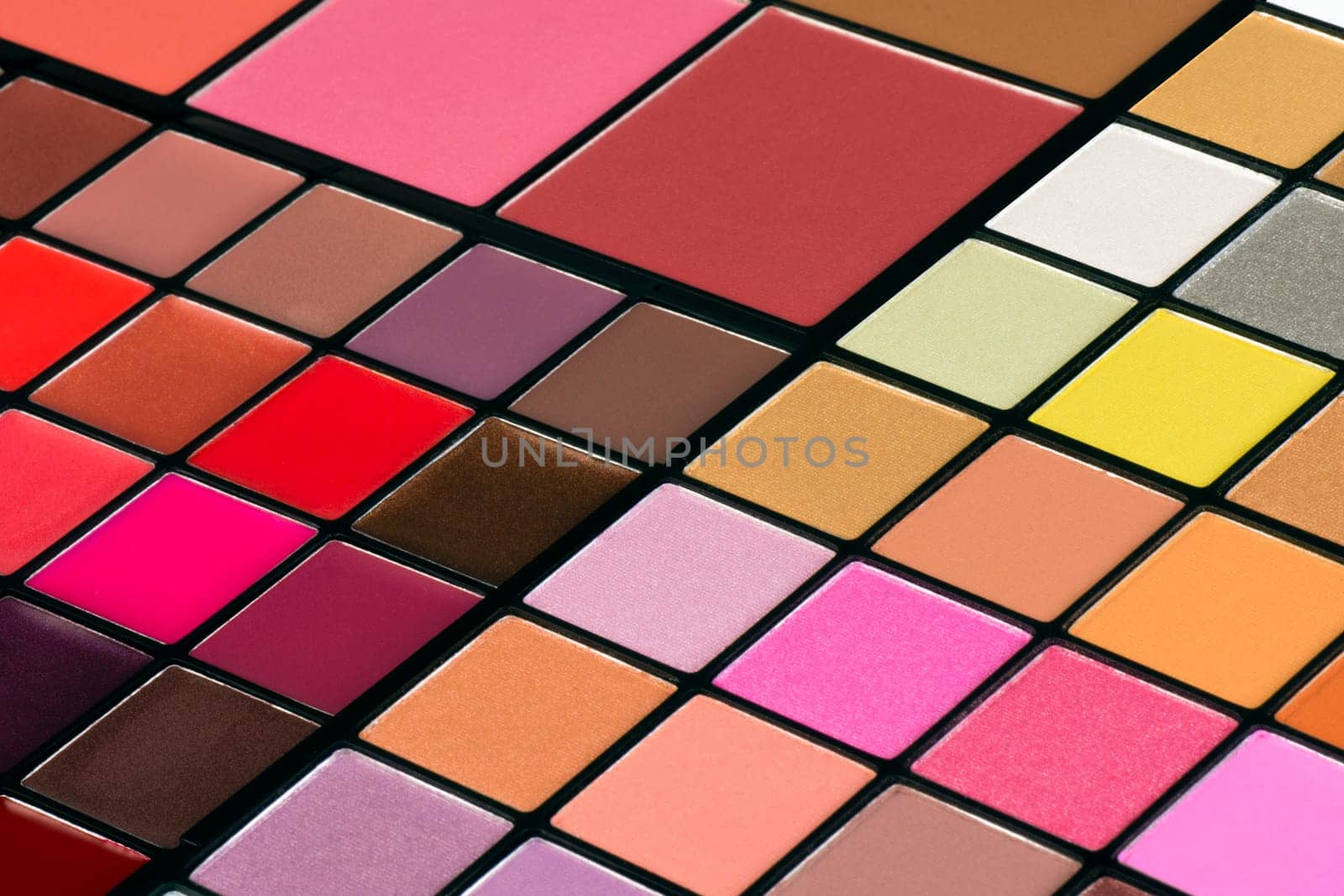 Colorful make-up palette with lipsticks and eye shadows.