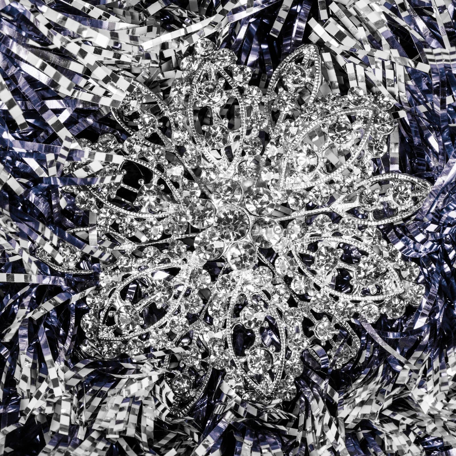 Silver jewelry is on abstract texture background.