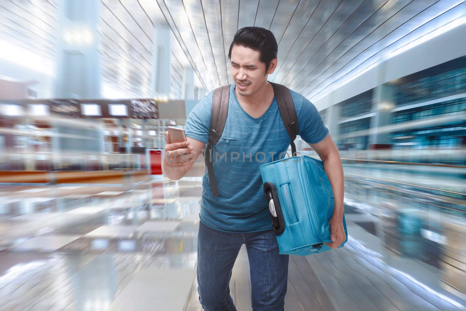 Young asian tourist rushing to boarding a plane on the departure area