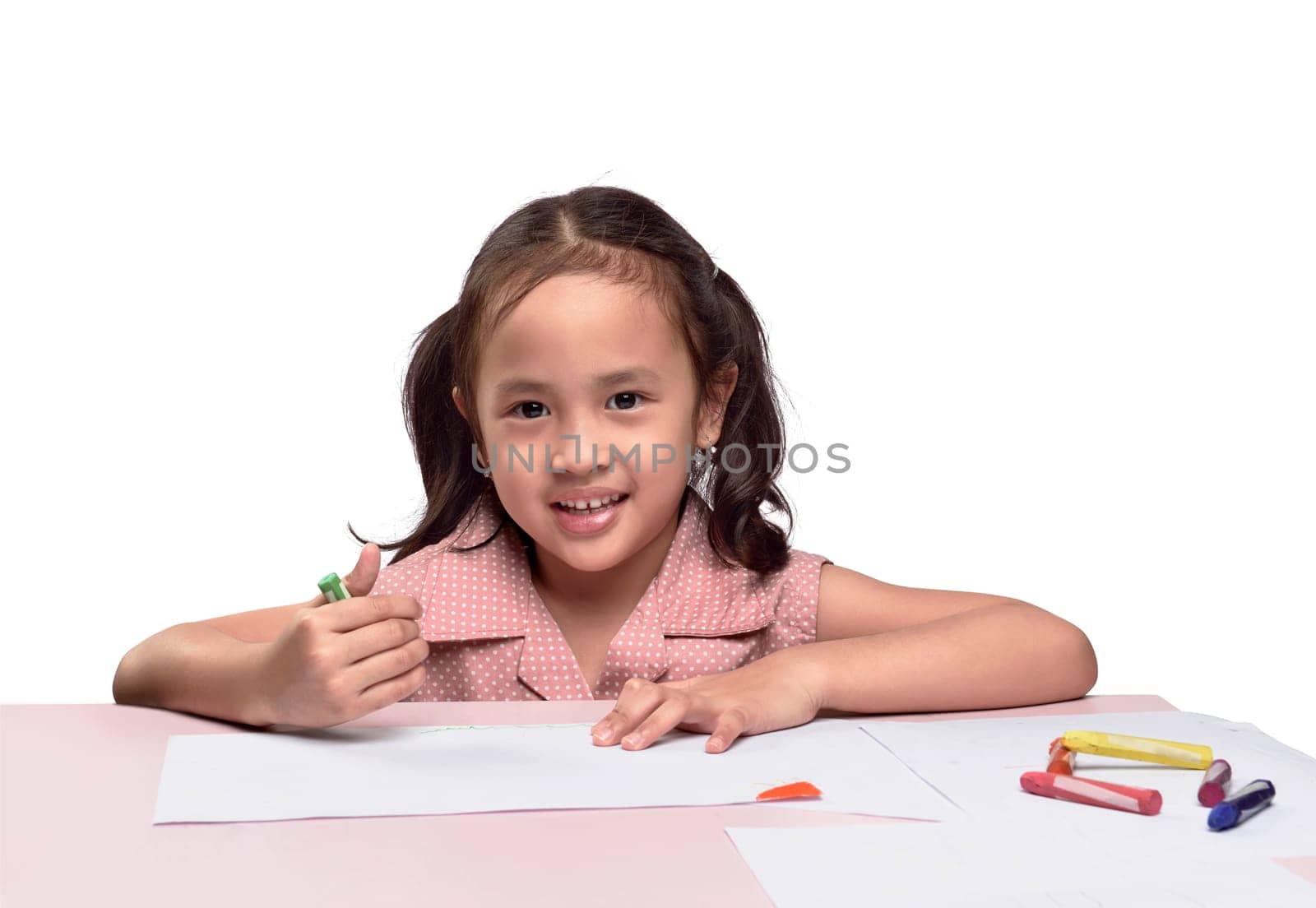 Portrait of lovely asian girl drawing with colorful crayon isolated over white background