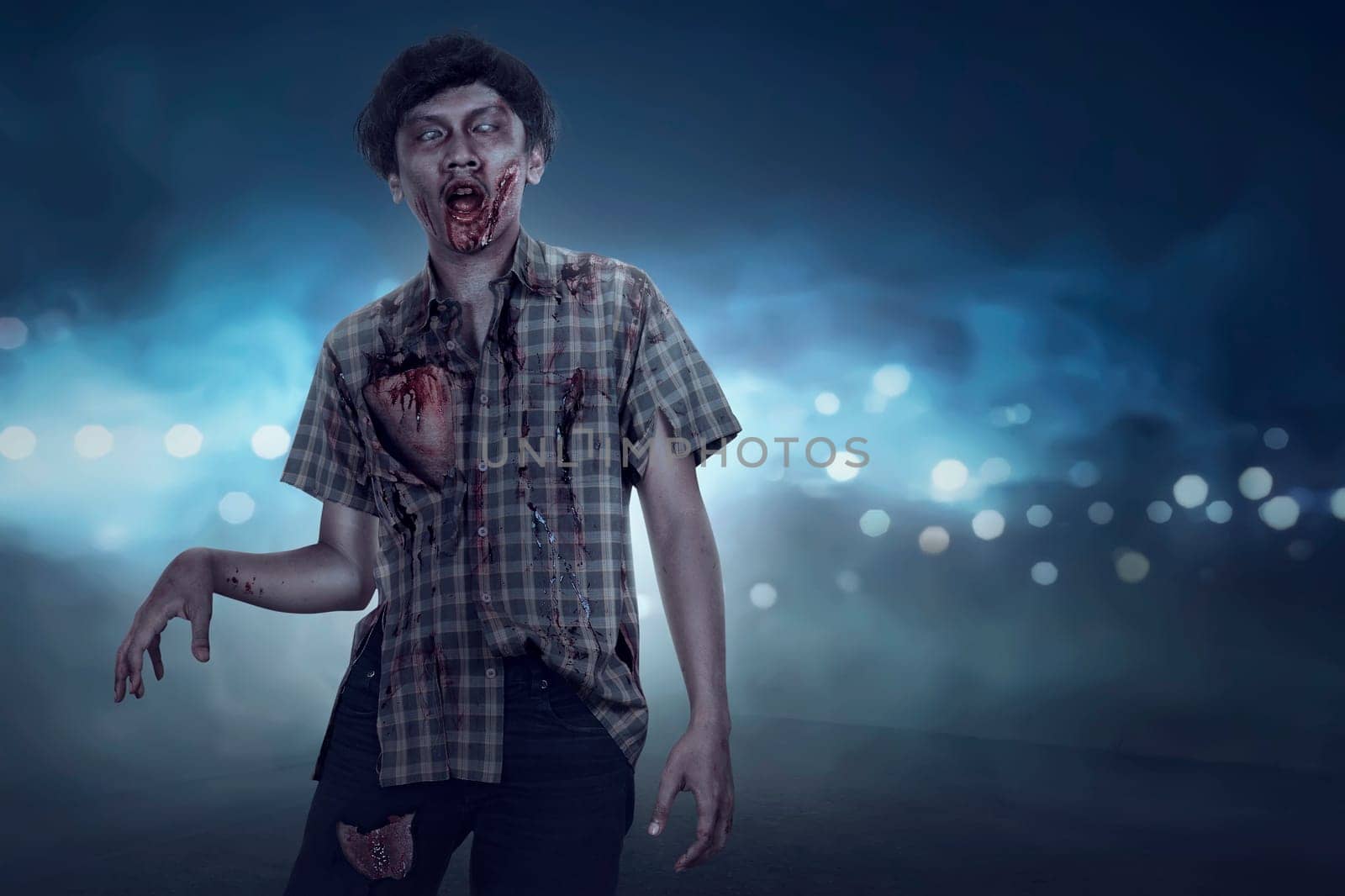 Aggressive spooky asian zombie man walking with streetlight background