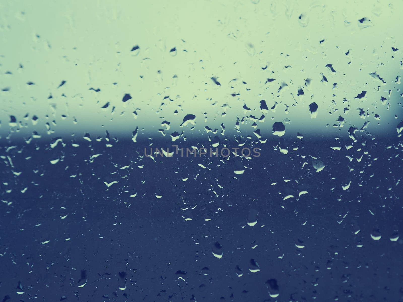 Dirty window close up on a rainy day, using as abstract background