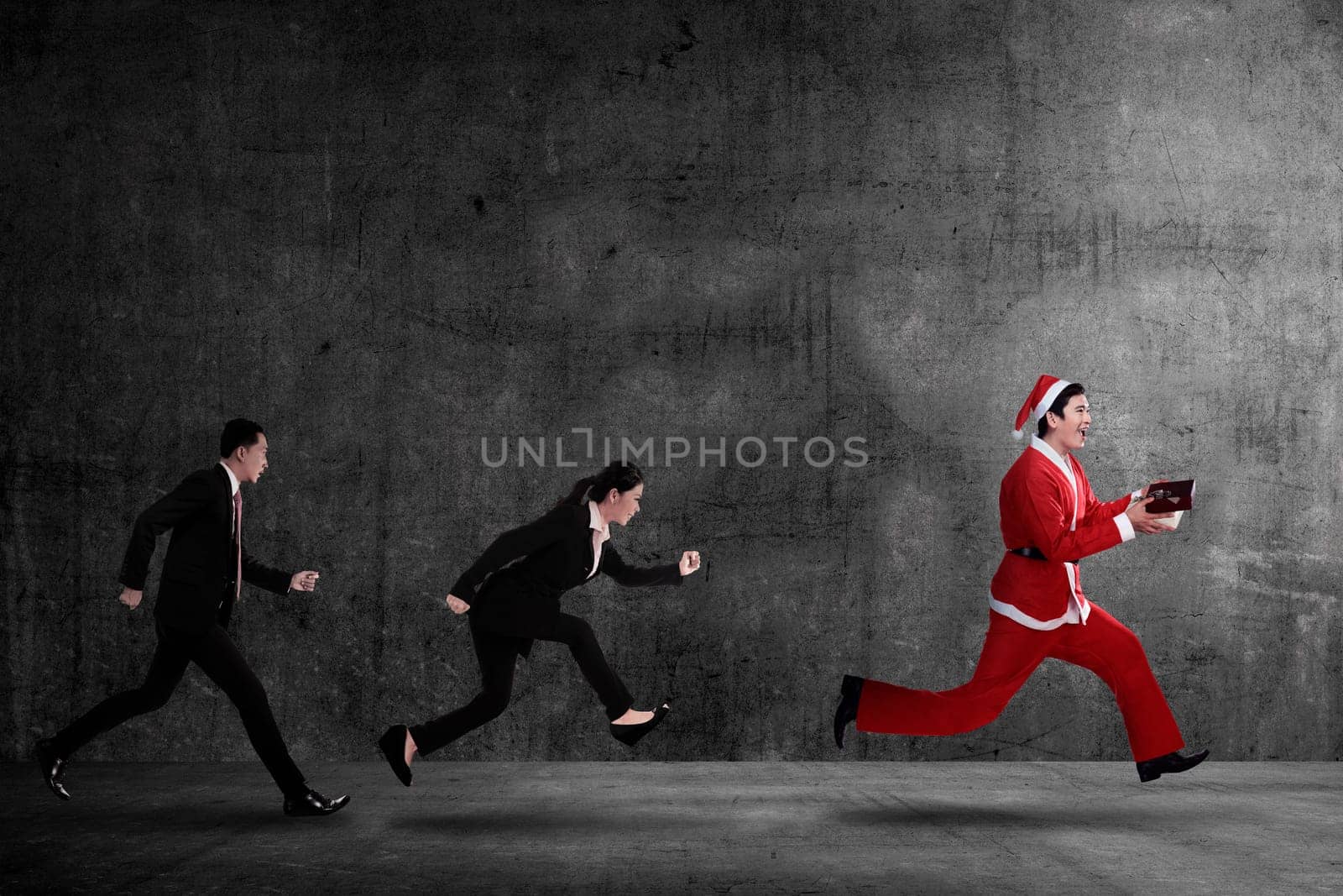 Business people chasing santa claus. Christmas bonus concept