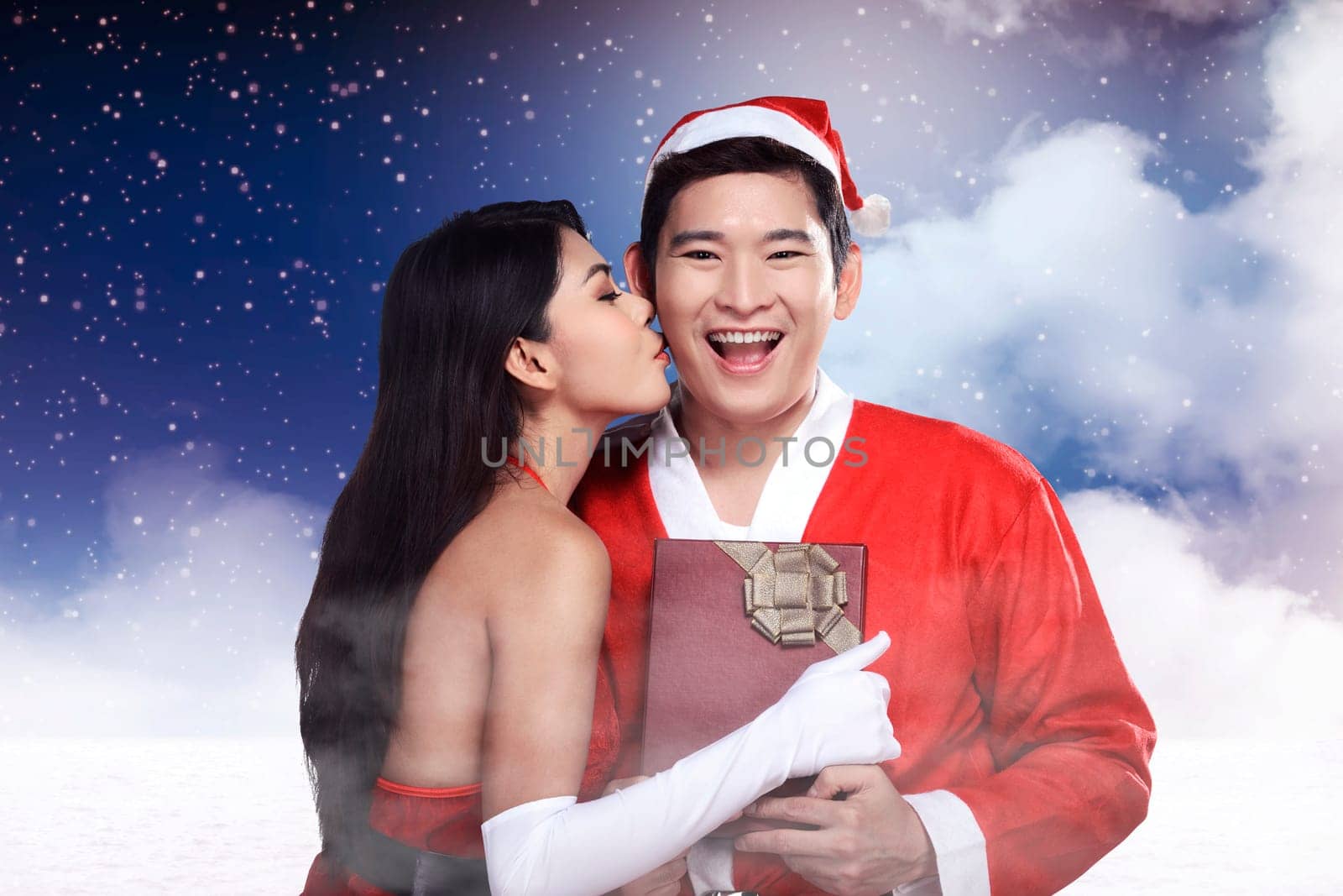 Santa woman give kiss to her lover. Christmas concept
