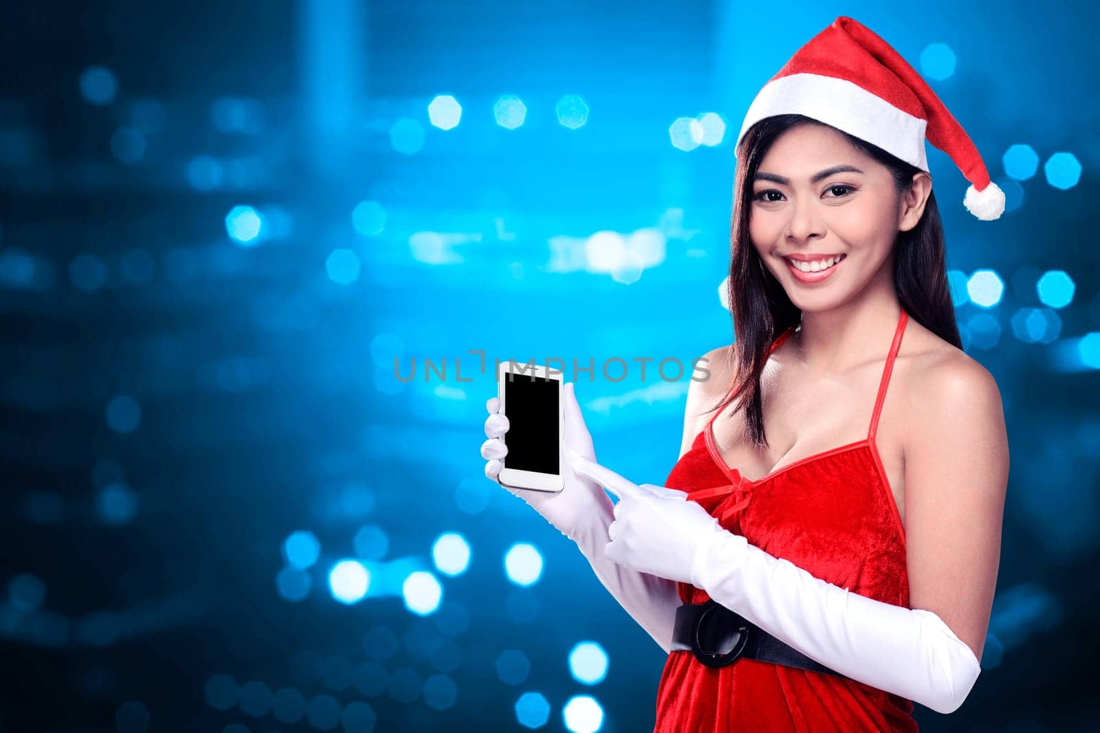 Asian woman in santa claus costume holding cellphone. Christmas concept