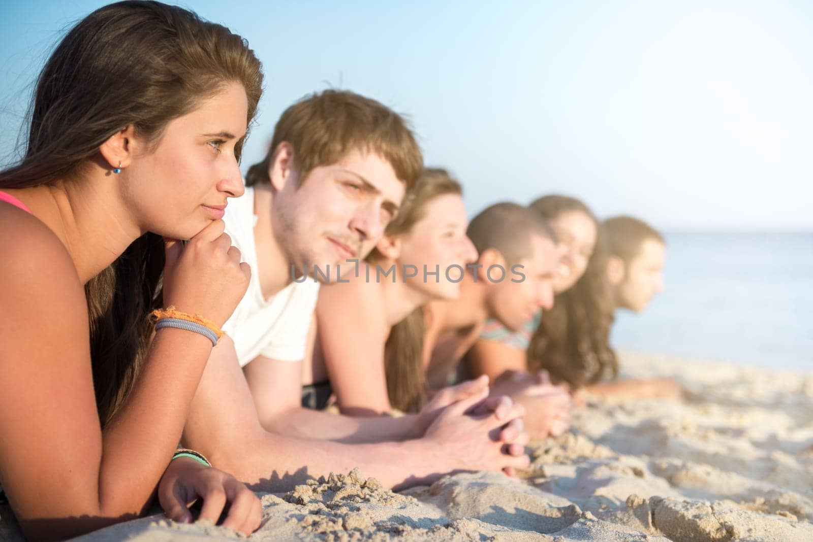 Group of happy teenage friends at the beach
