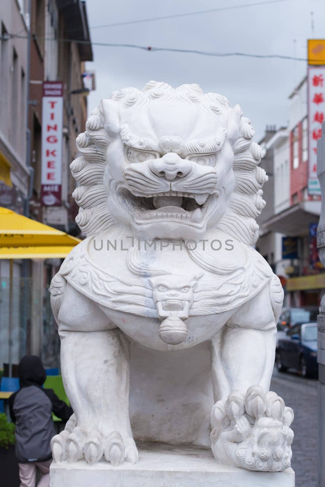 ANTWERP, BELGIUM - OCTOBER 2, 2016: Statue of a white chinese temple lion in front of the chinese area in antwerp