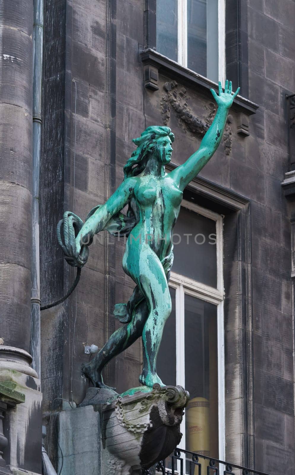 ANTWERP, BELGIUM - OCTOBER 2, 2016:  Bronze statue of a woman throwing a rope in the city center