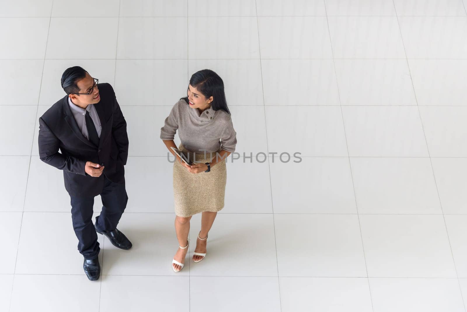 Top view, Asian business people, man and woman, talking about ideas, copy space, selective focus