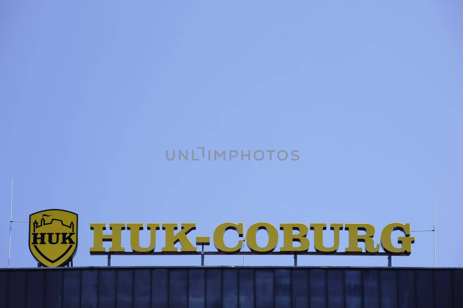 Mainz,Germany - July 06,2017: The yellow company sign and logo of the insurance company HUK Coburg on the roof edge of an office building on July 6,2017 in Mainz.