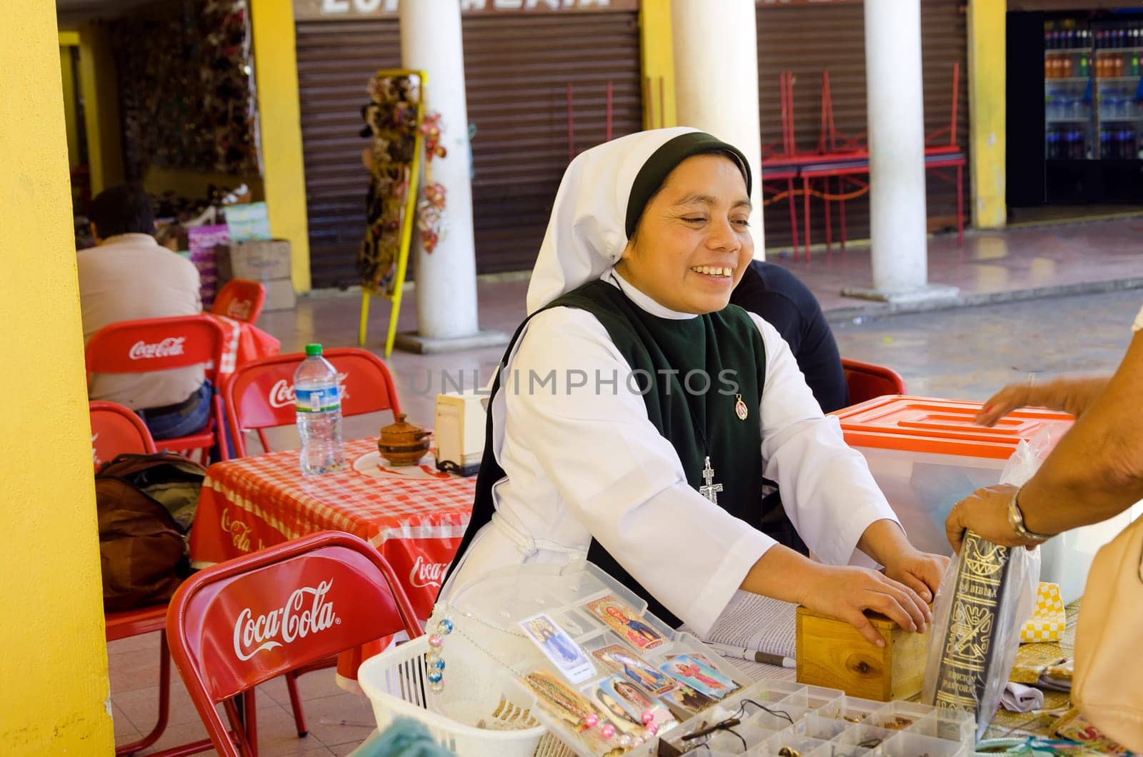 IZAMAL, MEXICO - FEBRUARY 19: Nun sells bibles in the market in Izamal, Mexico on February 19, 2017