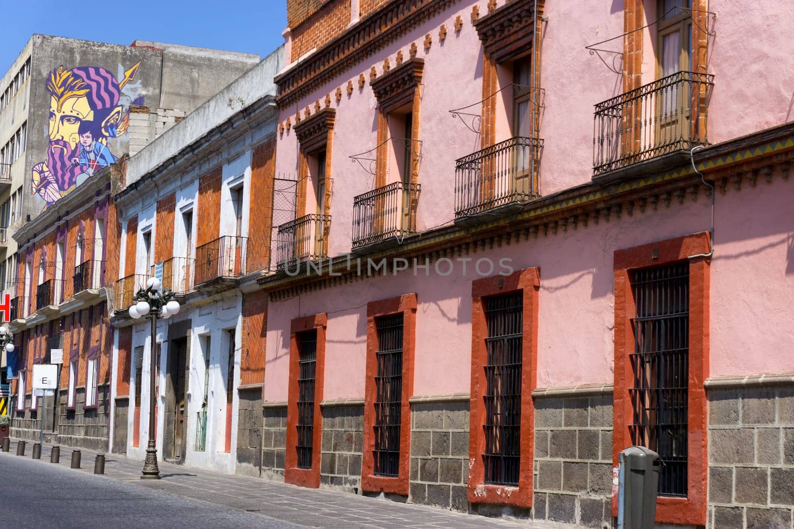 PUEBLA, MEXICO-MARCH 2: Red building in street in downtown in Puebla, Mexico on March 2, 2017