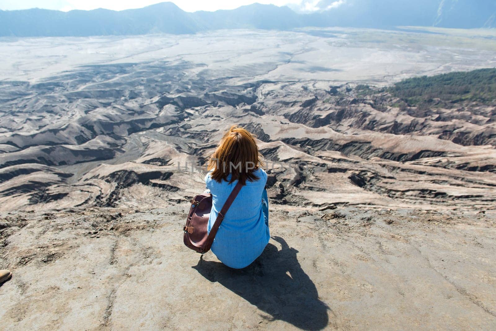 Woman on top of Layer Volcanic ash as sand ground of Mount Bromo volcano (Gunung Bromo) at Bromo Tengger Semeru National Park, East Java, Indonesia.