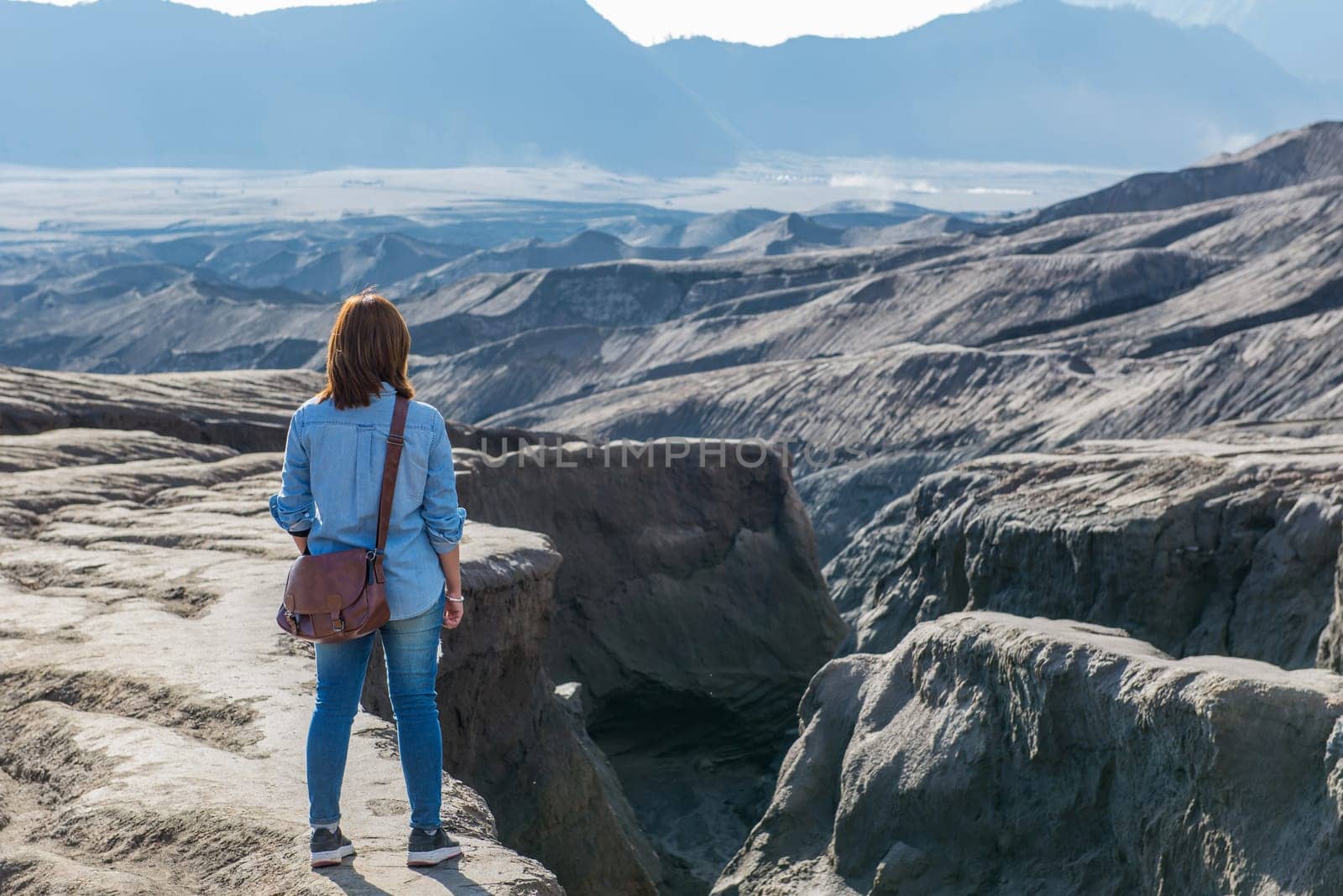 Woman on top of Layer Volcanic ash as sand ground of Mount Bromo volcano (Gunung Bromo) at Bromo Tengger Semeru National Park, East Java, Indonesia.