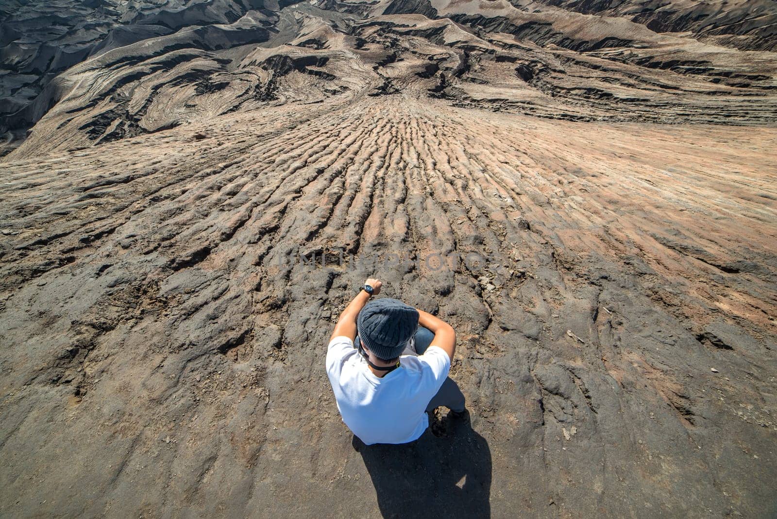 Man on top of Layer Volcanic ash as sand ground of Mount Bromo volcano (Gunung Bromo) at Bromo Tengger Semeru National Park, East Java, Indonesia.