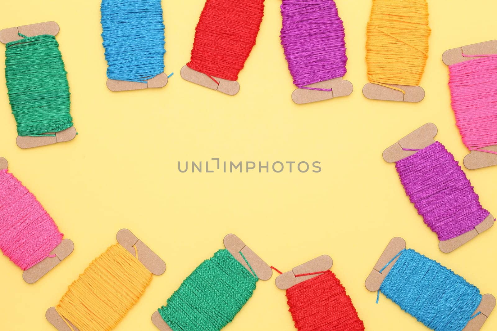 colorful thread spools - needlework, craft, sewing and tailoring concept