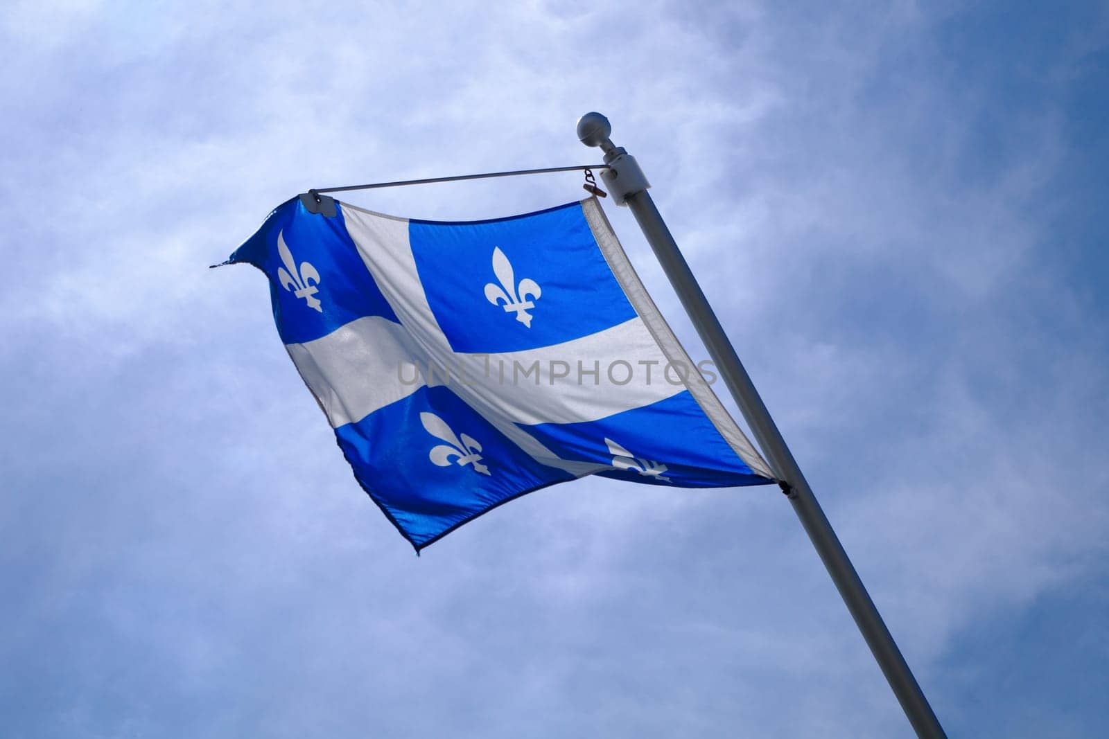 Quebec Flag pole on blue sky national st-jean banner