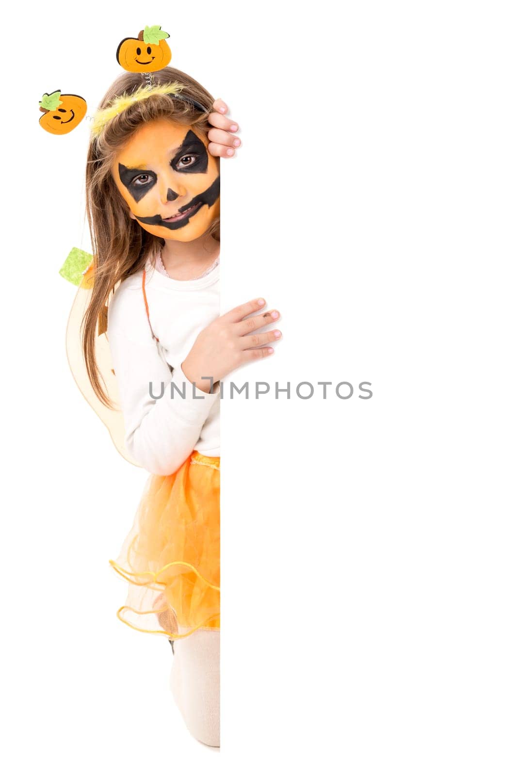 Girl with face-paint and Halloween pumpkin costume isolated in white
