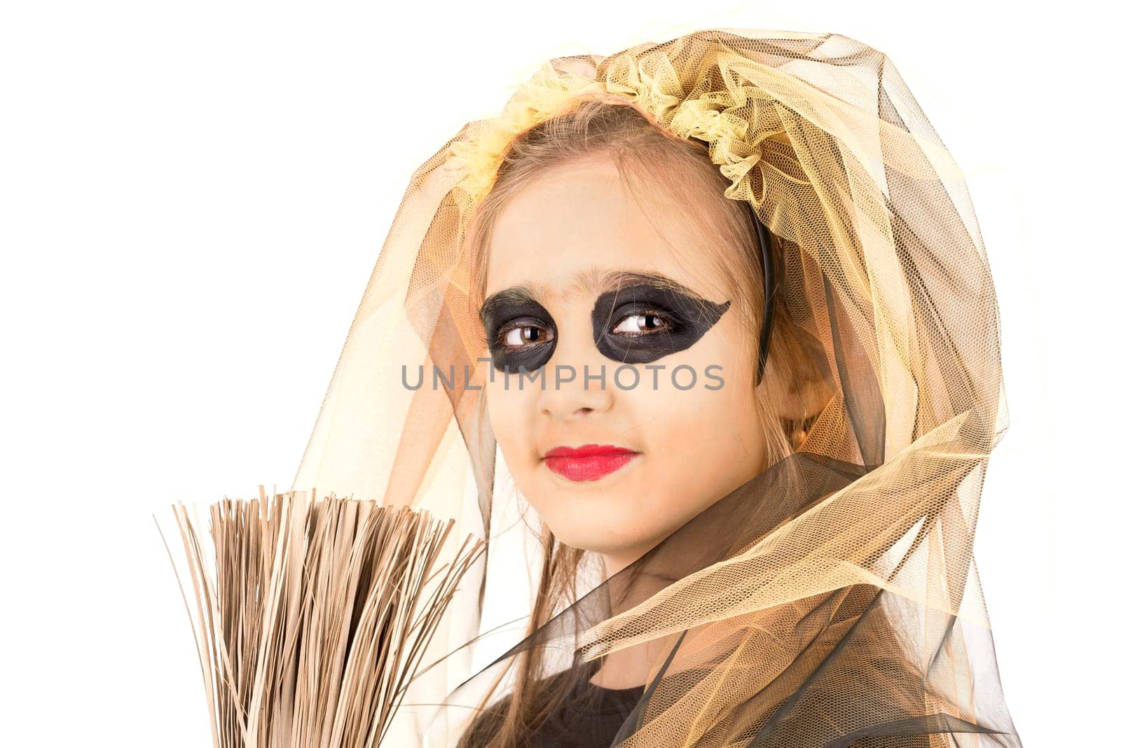 Girl with face-paint and Halloween witch costume over a white background