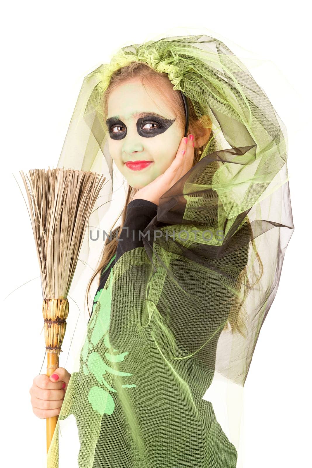 Girl with face-paint and Halloween witch costume over a white background