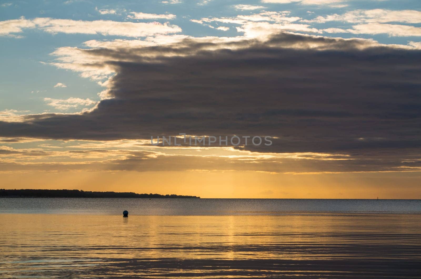 Beautiful sunrise in the summer over silent glossy sea And clouds in the sky . Panorama