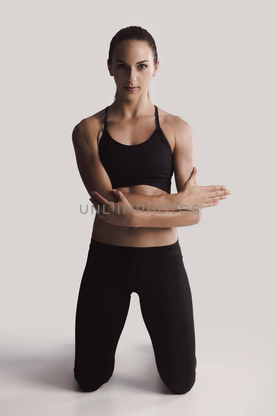 Shot of a young woman doing stretching exercises