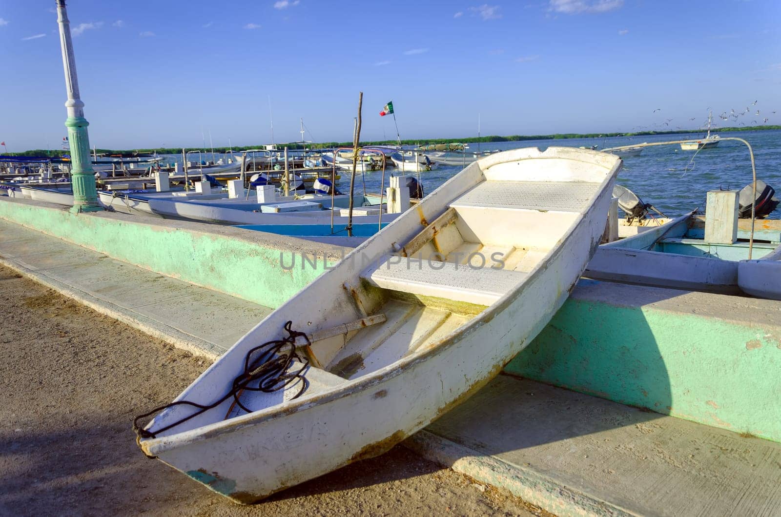 Old boat in waterfront in Rio Lagartos, Mexico