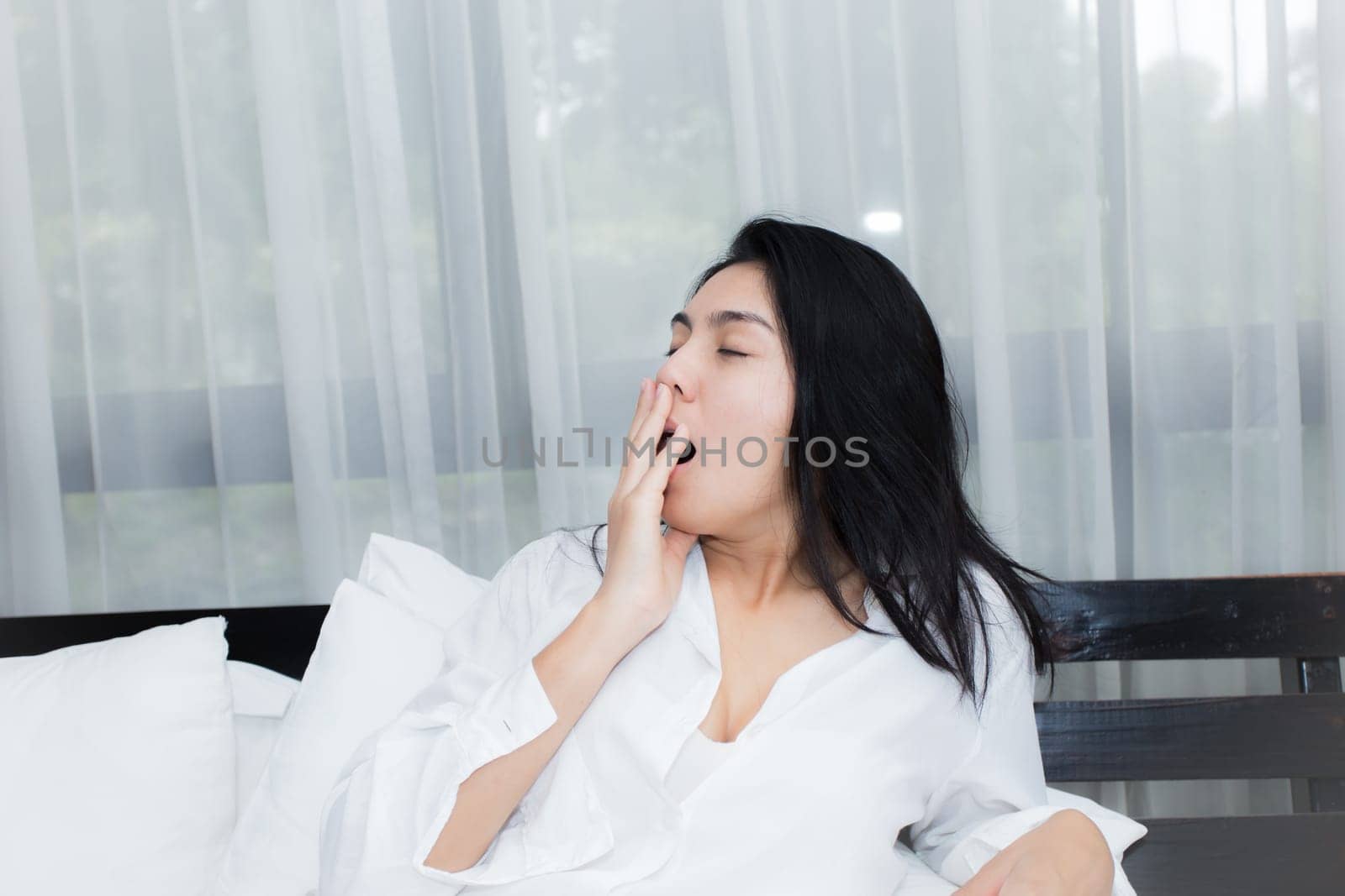 Happy young beauty women sleeping and smile on bed in the morning