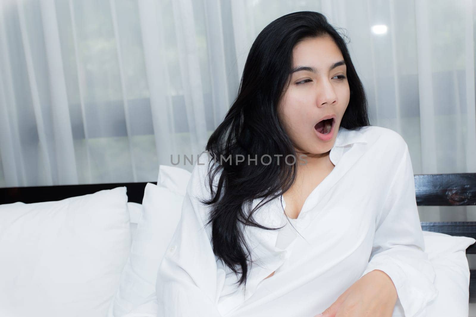 Happy young beauty women sleeping and smile on bed in the morning