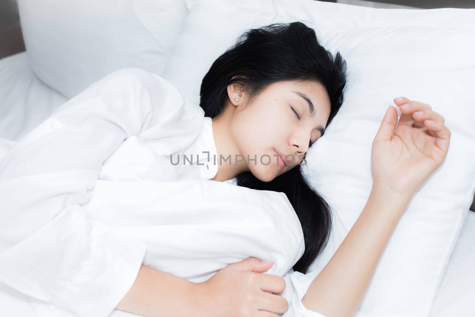 Happy young beauty women sleeping and smile on bed in the morning