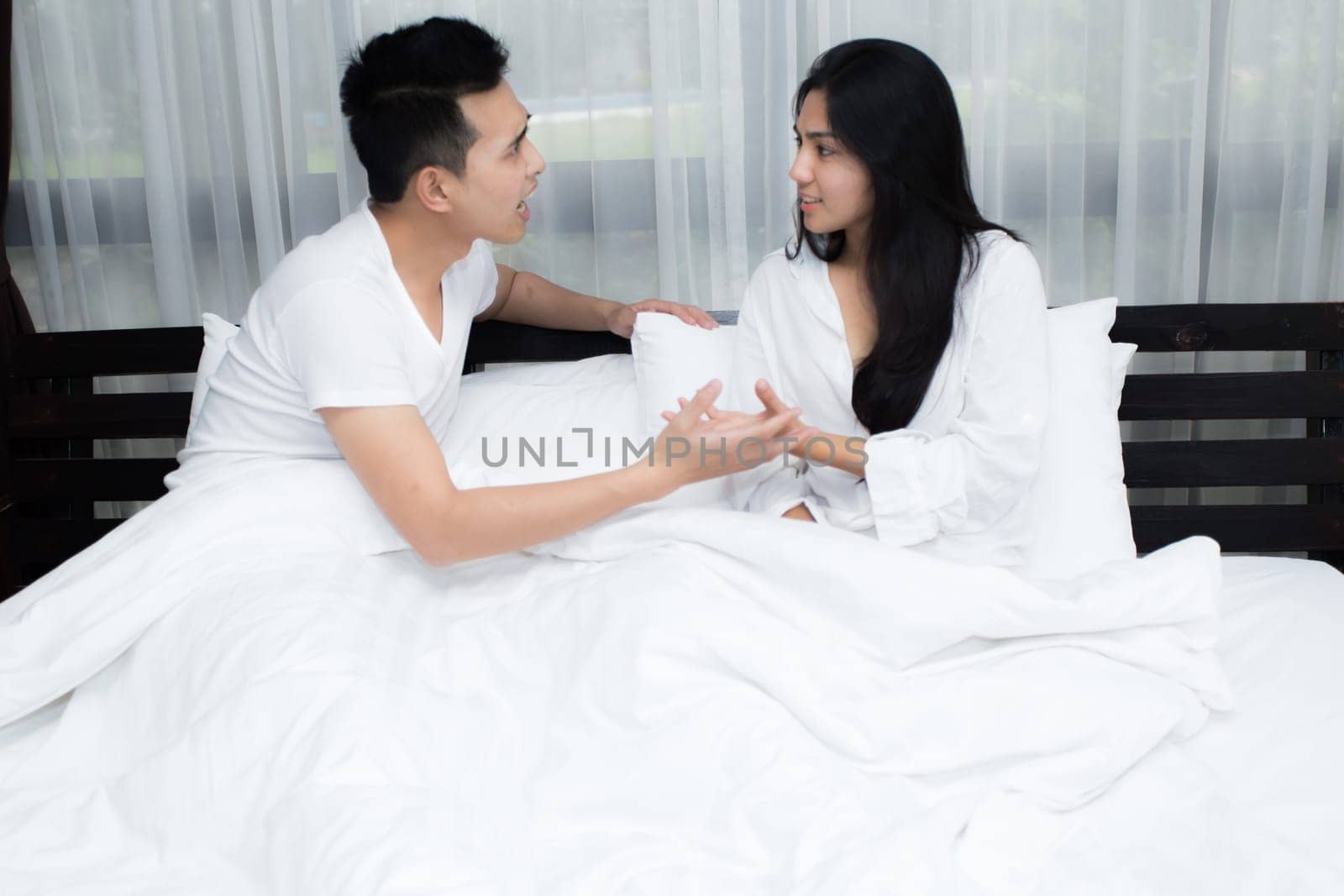 Young loving couple on the bed in the morning