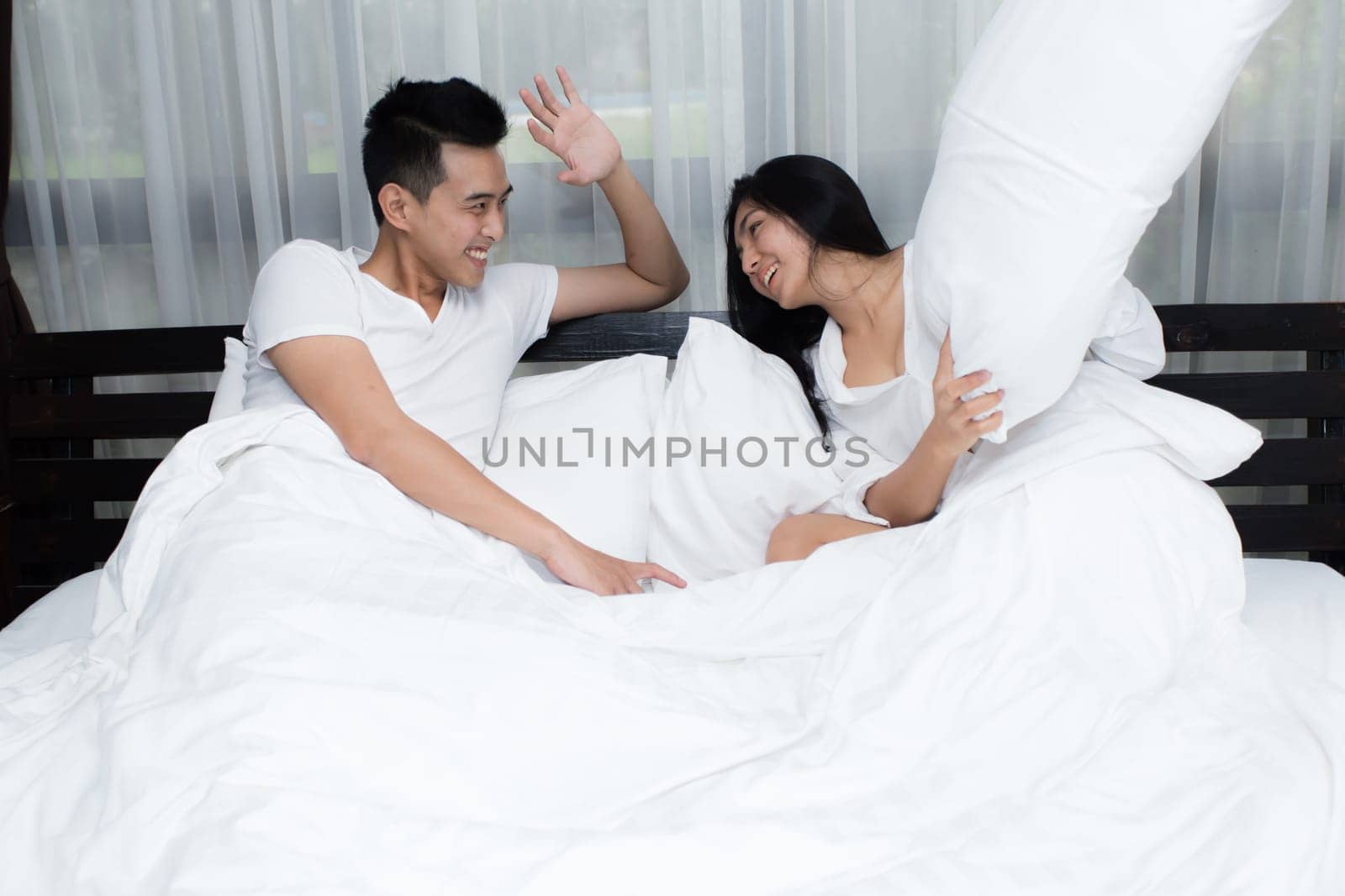 Young loving couple on the bed in the morning