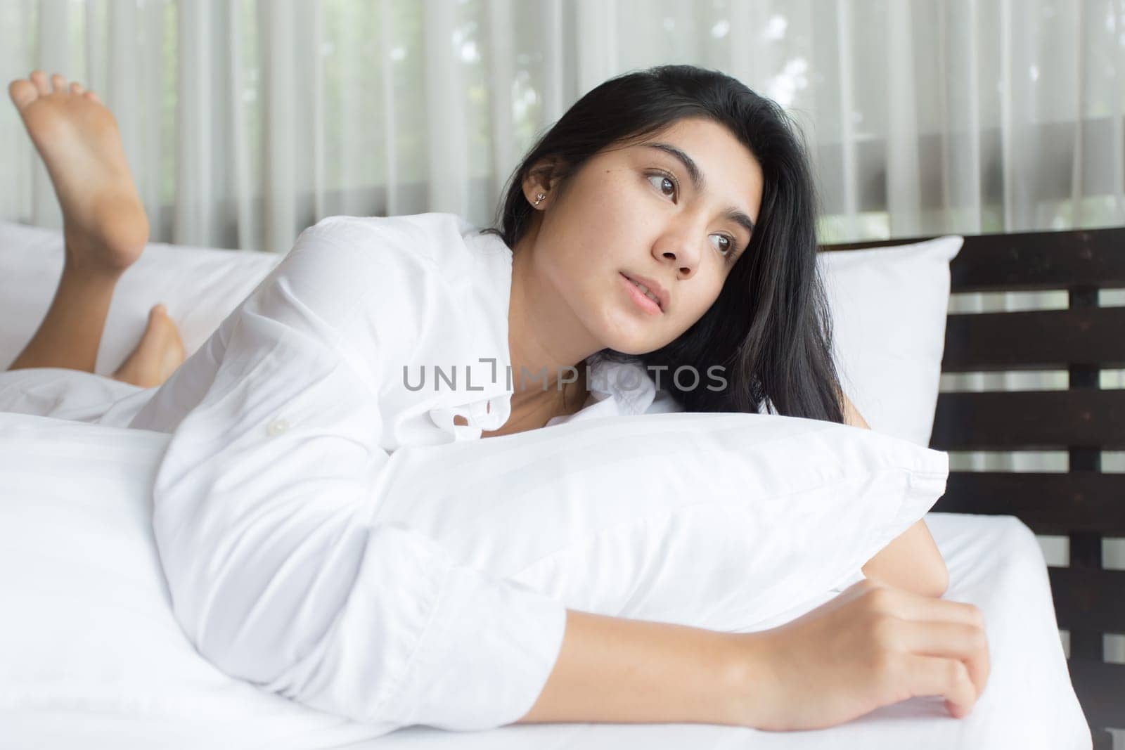 Happy young beauty women sleeping and smile on bed in the morning