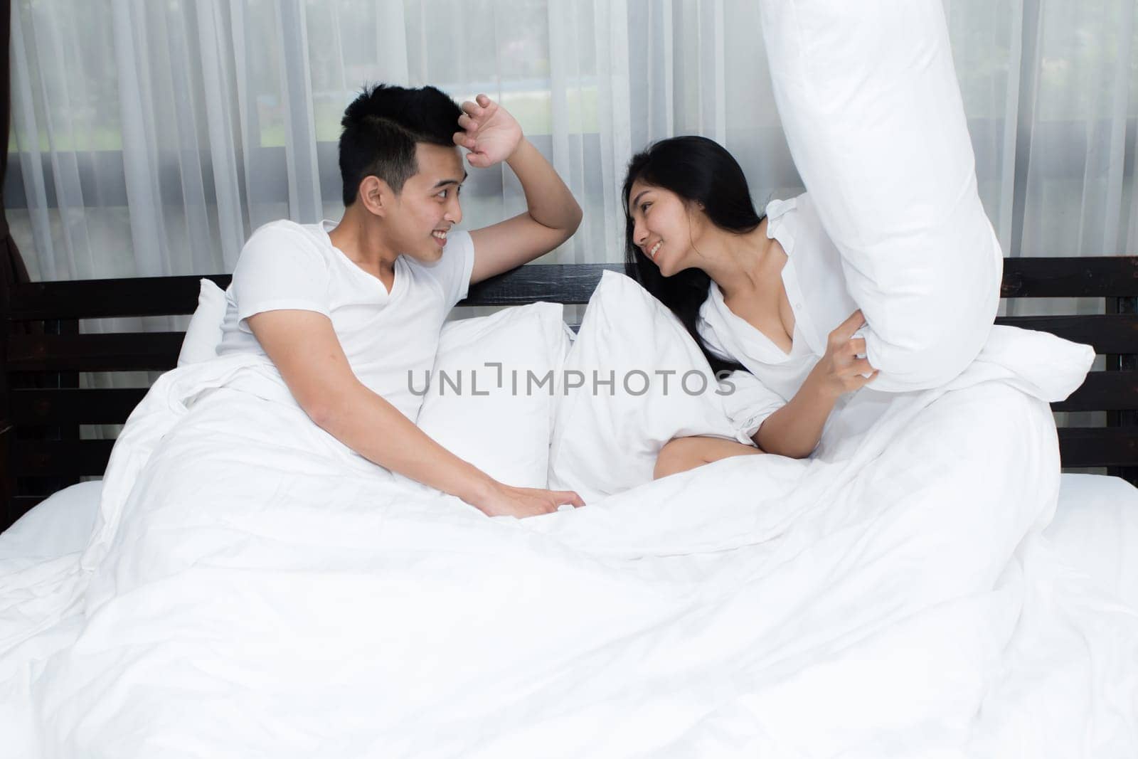 Young loving couple on the bed in the morning