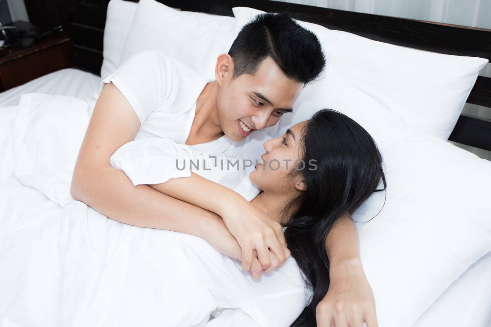 Unhappy couple having problems at bedroom in the morning