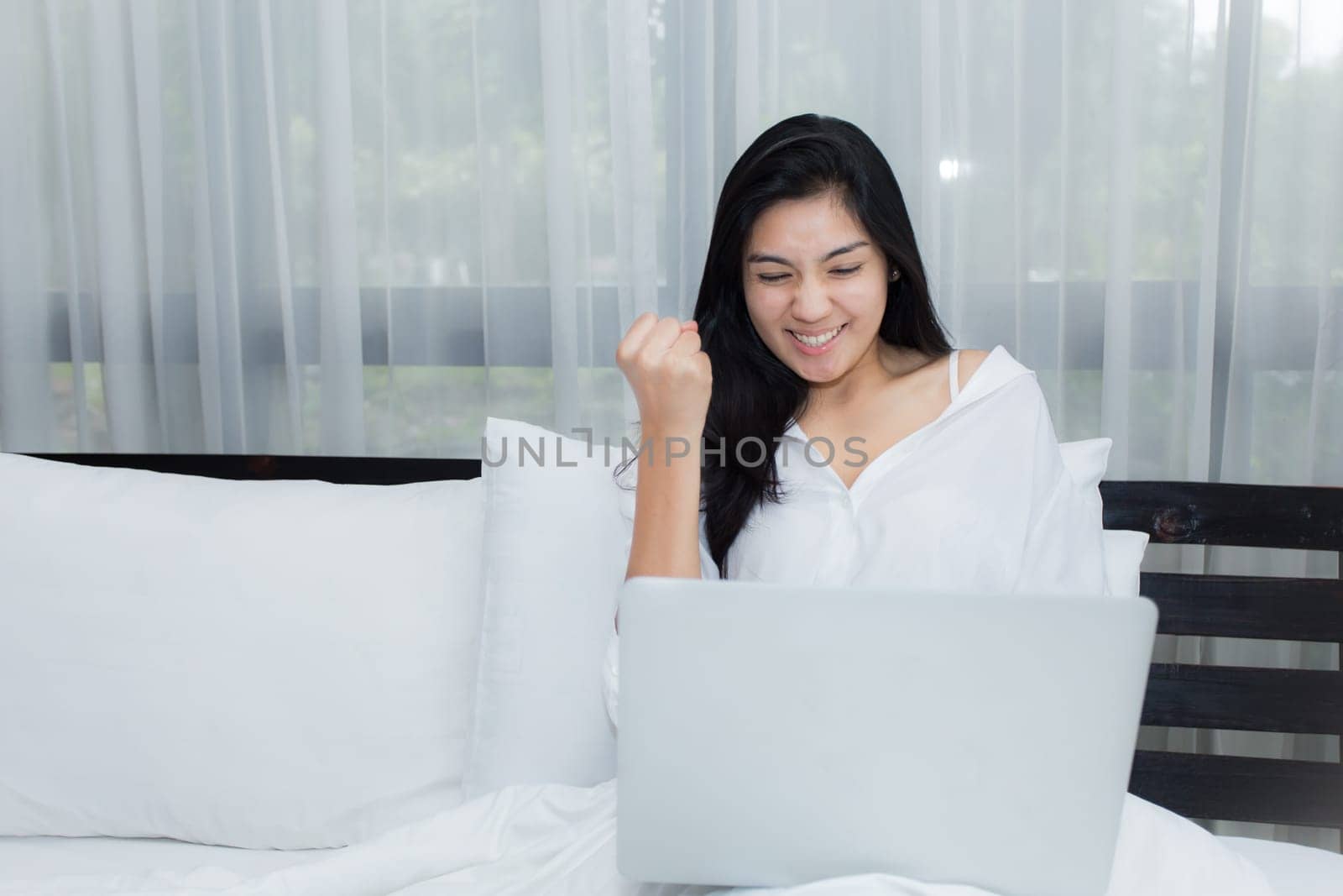 Young asian woman taking photos in autumn forest with camera